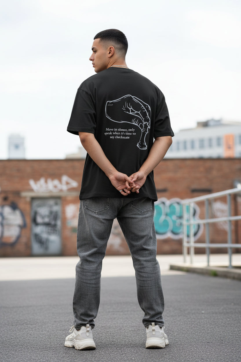 Black t-shirt with a white graphic and text on the back, displayed against a light gray background.